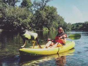 a group of people riding on the back of a boat in the water