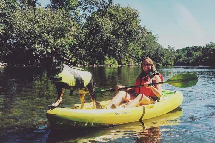 a group of people riding on the back of a boat in the water