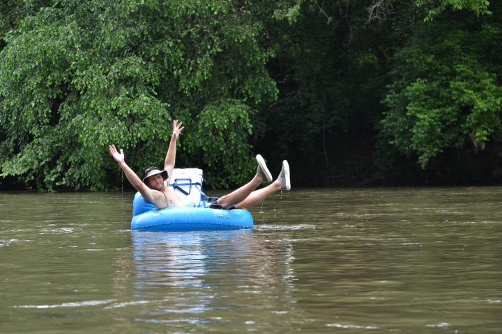 a man riding on the back of a boat in the water