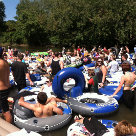 a group of people on a motorcycle in front of a crowd