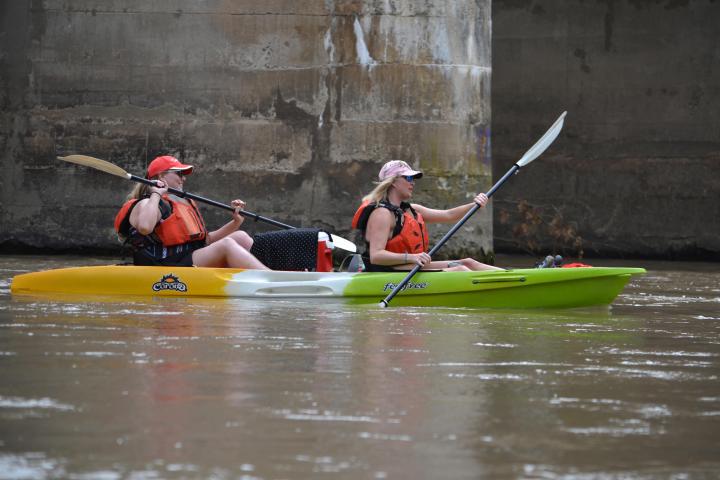 a person riding on the back of a boat in the water