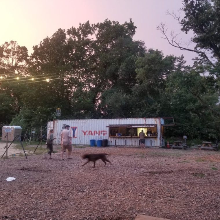 a group of people walking down a dirt road