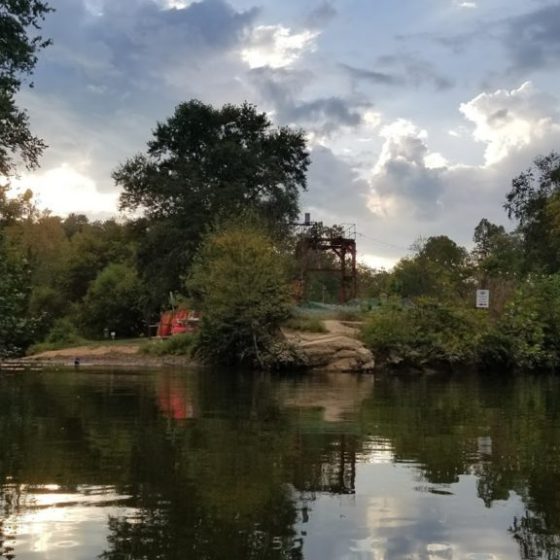 a body of water surrounded by trees