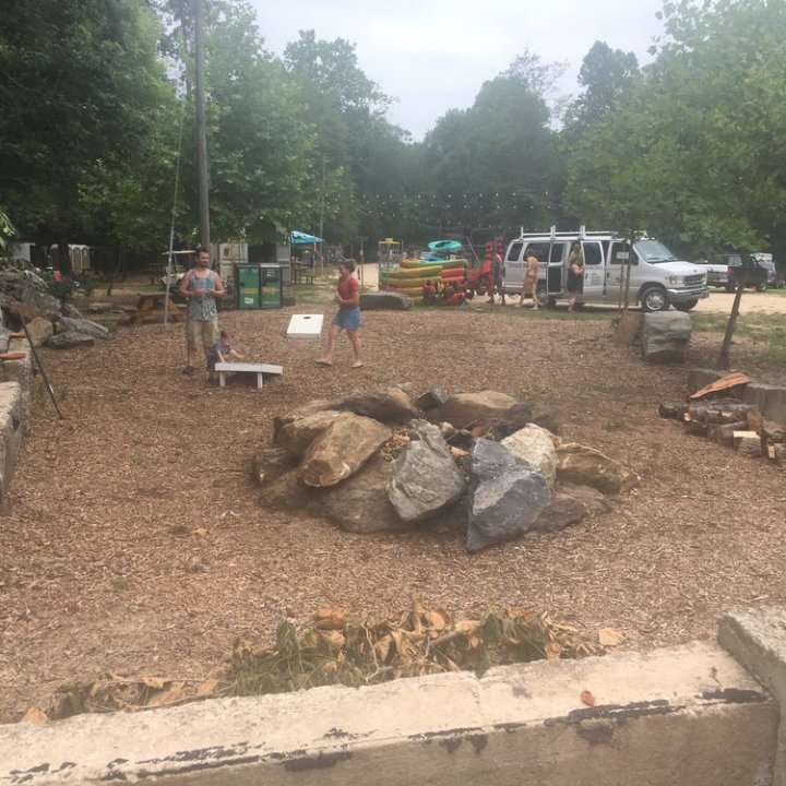 a group of people walking down a dirt road